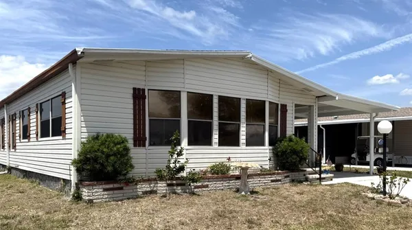 a front view of a house with sitting area
