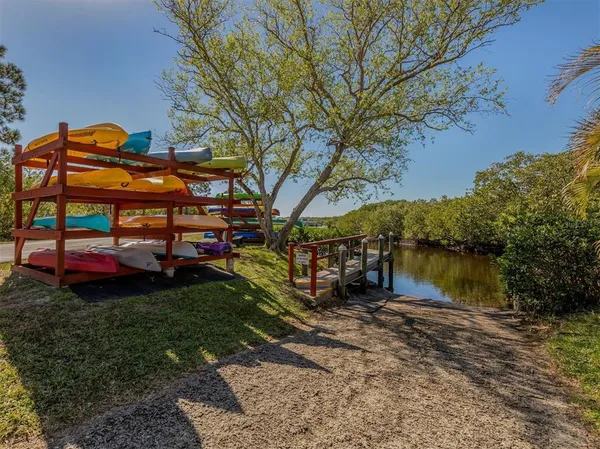 a view of a lake with table and chairs