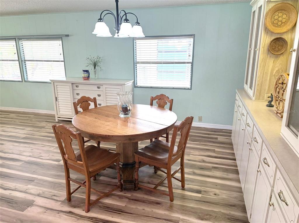 122 Rarotonga Road North Port, FL 34287 - Photo 10 of 48 a view of a dining room with furniture and wooden floor