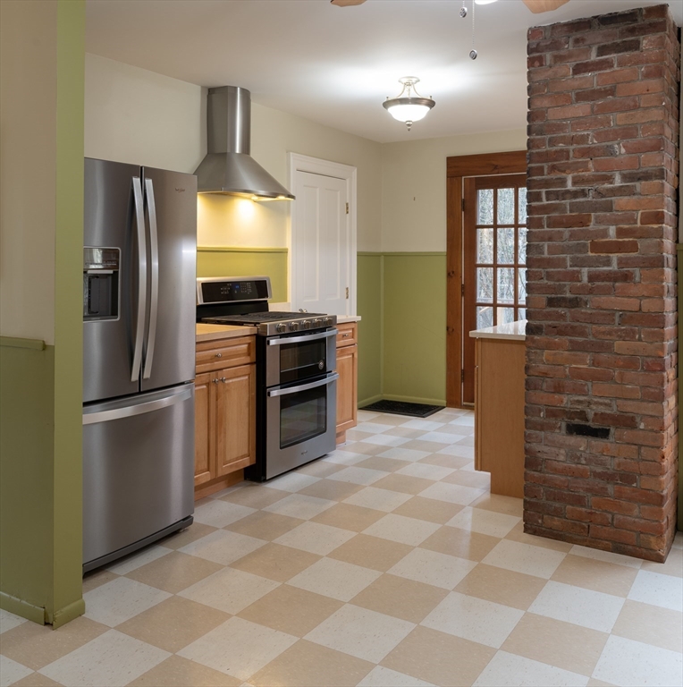 29 Pomeroy Terrace Northampton, MA 01060 - Photo 12 of 23 a kitchen with granite countertop a refrigerator and a stove top oven