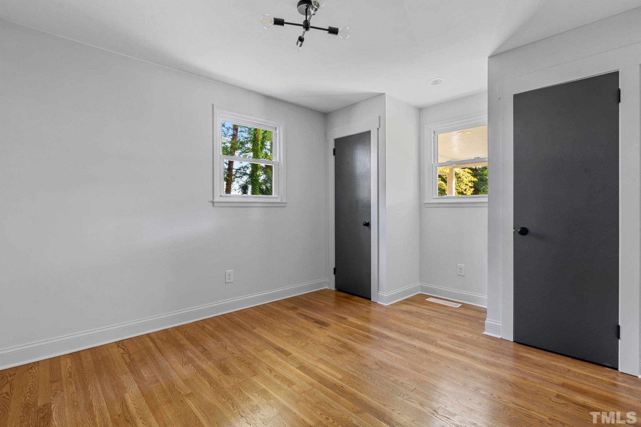317 Quail Drive Raleigh, NC 27604 - Photo 11 of 29 wooden floor in an empty room with a window