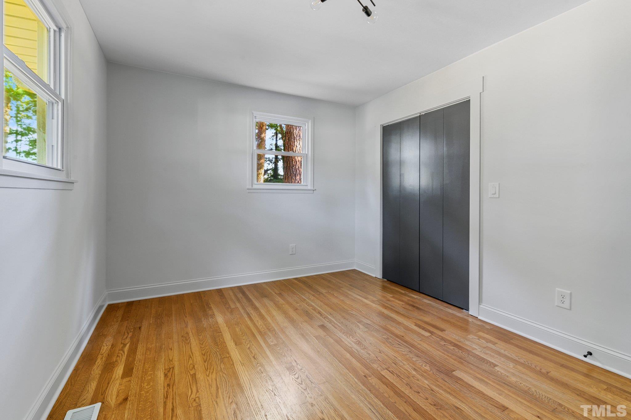 317 Quail Drive Raleigh, NC 27604 - Photo 12 of 29 a view of empty room with wooden floor