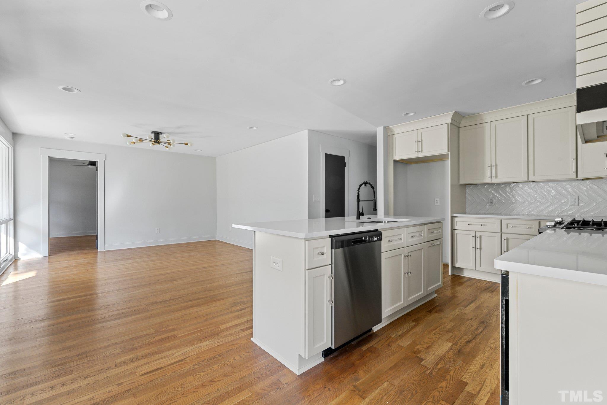 317 Quail Drive Raleigh, NC 27604 - Photo 18 of 29 a kitchen with granite countertop a stove top oven and cabinets