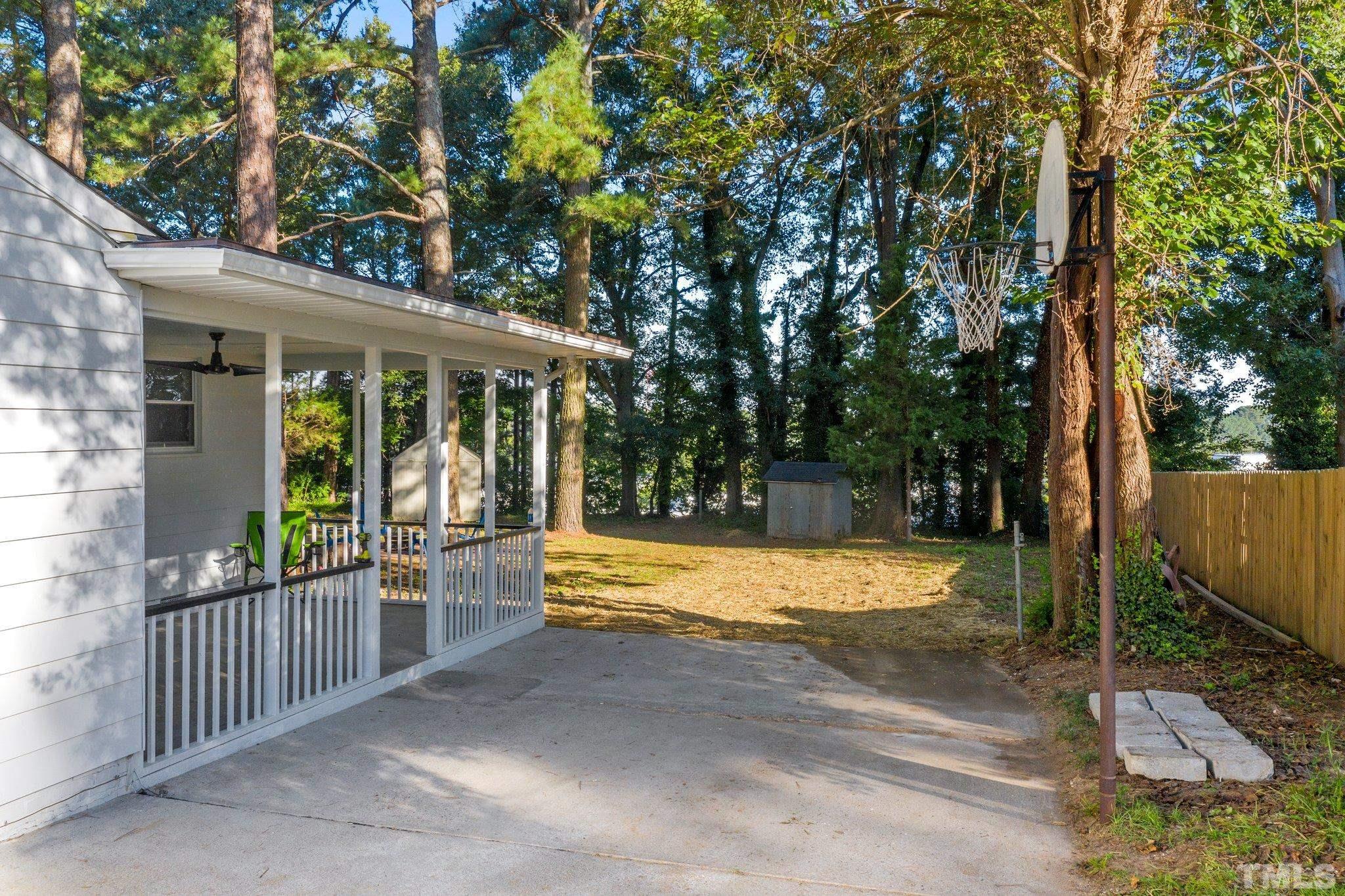 317 Quail Drive Raleigh, NC 27604 - Photo 22 of 29 a view of a house with backyard and a large tree