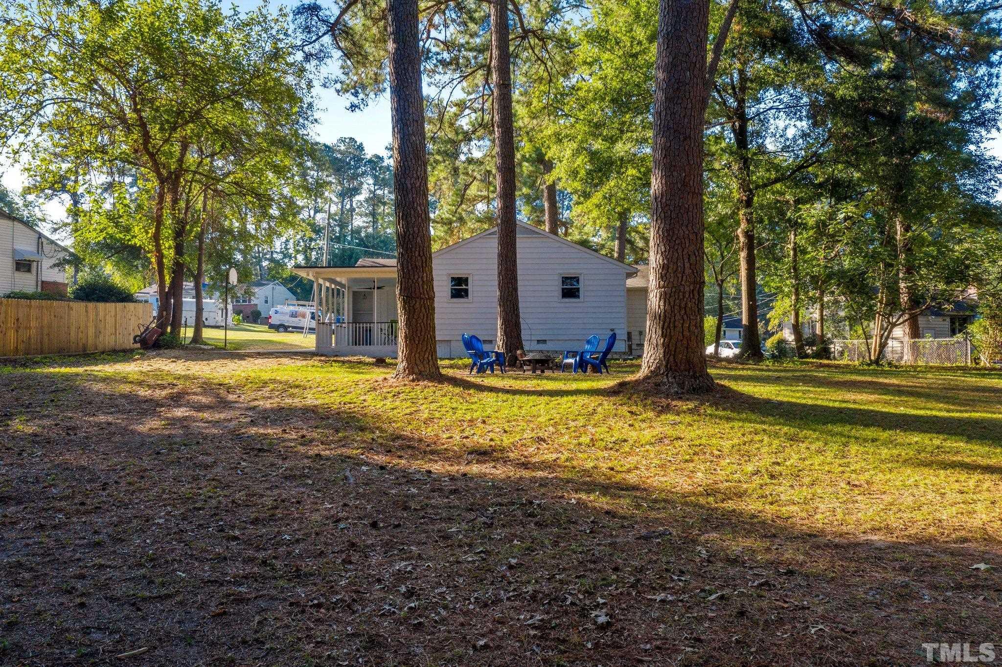 317 Quail Drive Raleigh, NC 27604 - Photo 25 of 29 a view of a house with large trees and a yard with swimming pool