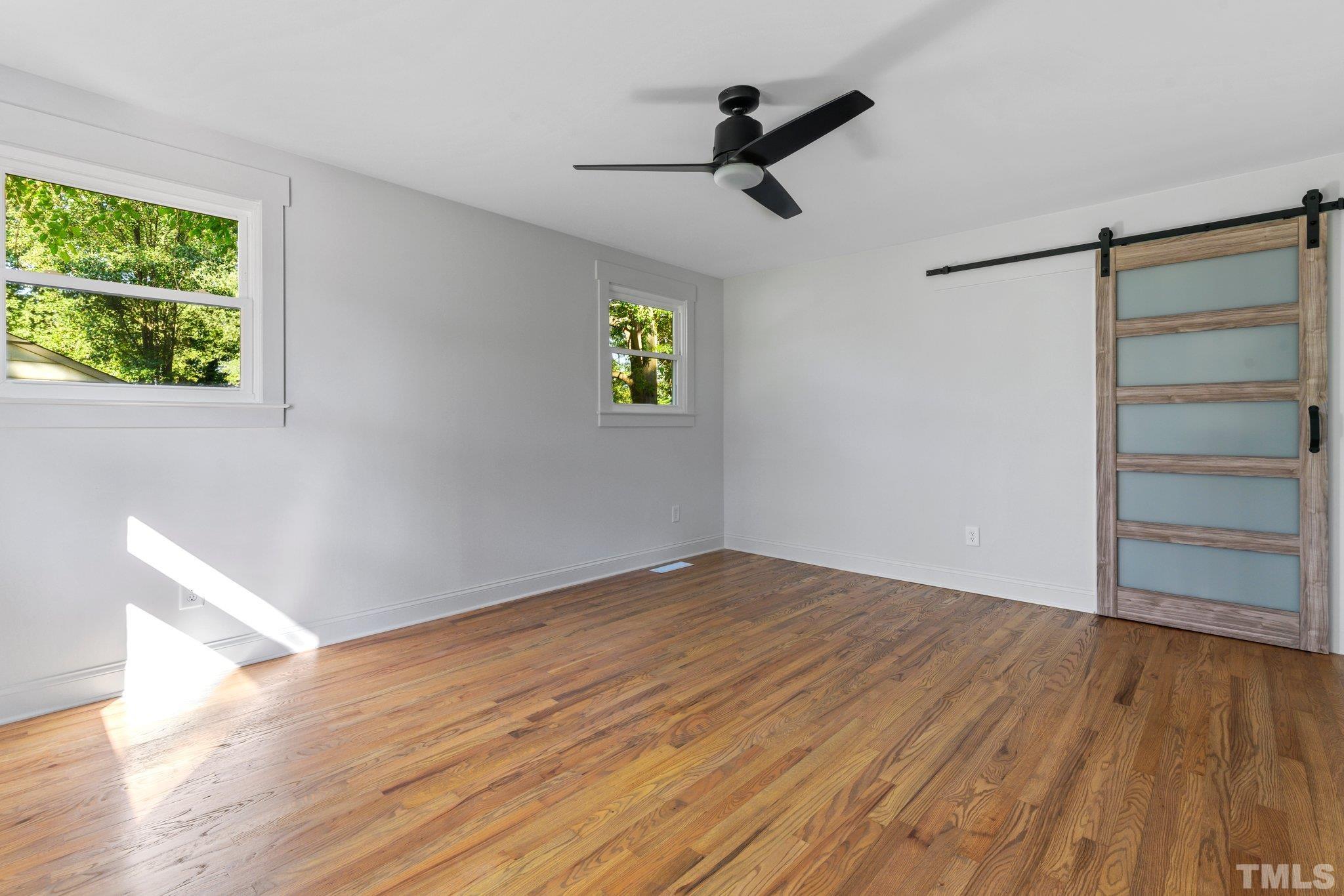317 Quail Drive Raleigh, NC 27604 - Photo 6 of 29 a view of empty room with wooden floor and window