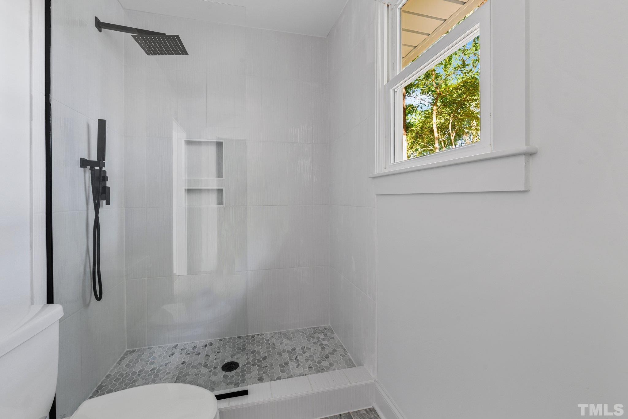 317 Quail Drive Raleigh, NC 27604 - Photo 9 of 29 a bathroom with a toilet and a shower