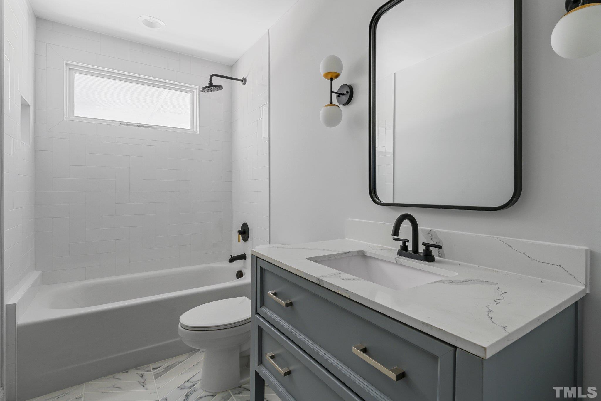 317 Quail Drive Raleigh, NC 27604 - Photo 10 of 29 a bathroom with a sink toilet vanity and shower