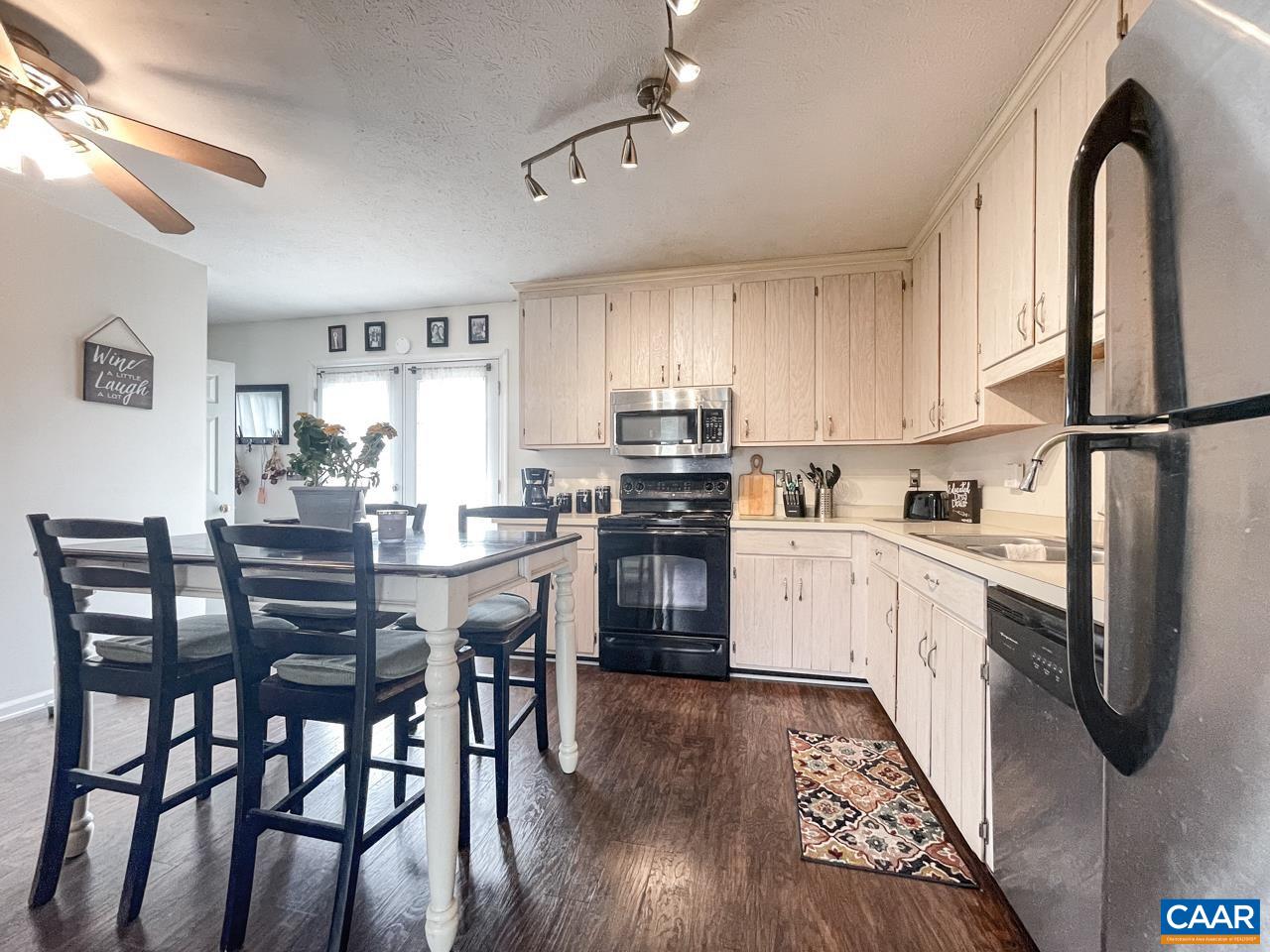 39 East Daffodil Road Ruckersville, VA 22968 - Photo 11 of 28 a kitchen with stainless steel appliances granite countertop a refrigerator a stove top oven a sink dishwasher and white cabinets with wooden floor
