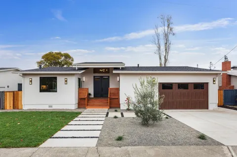 a front view of a house with garden
