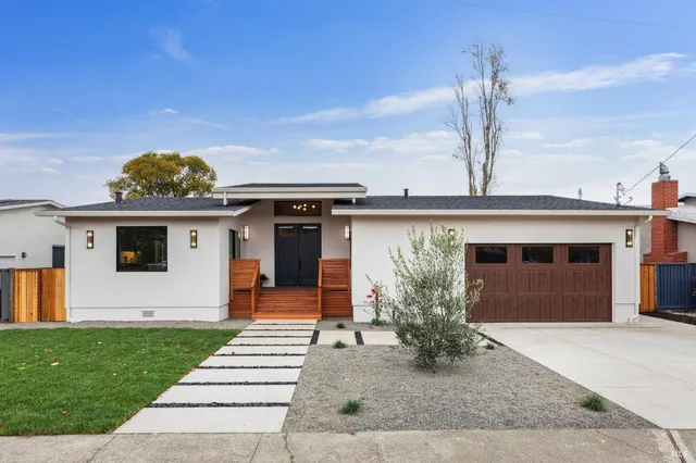 a front view of a house with garden