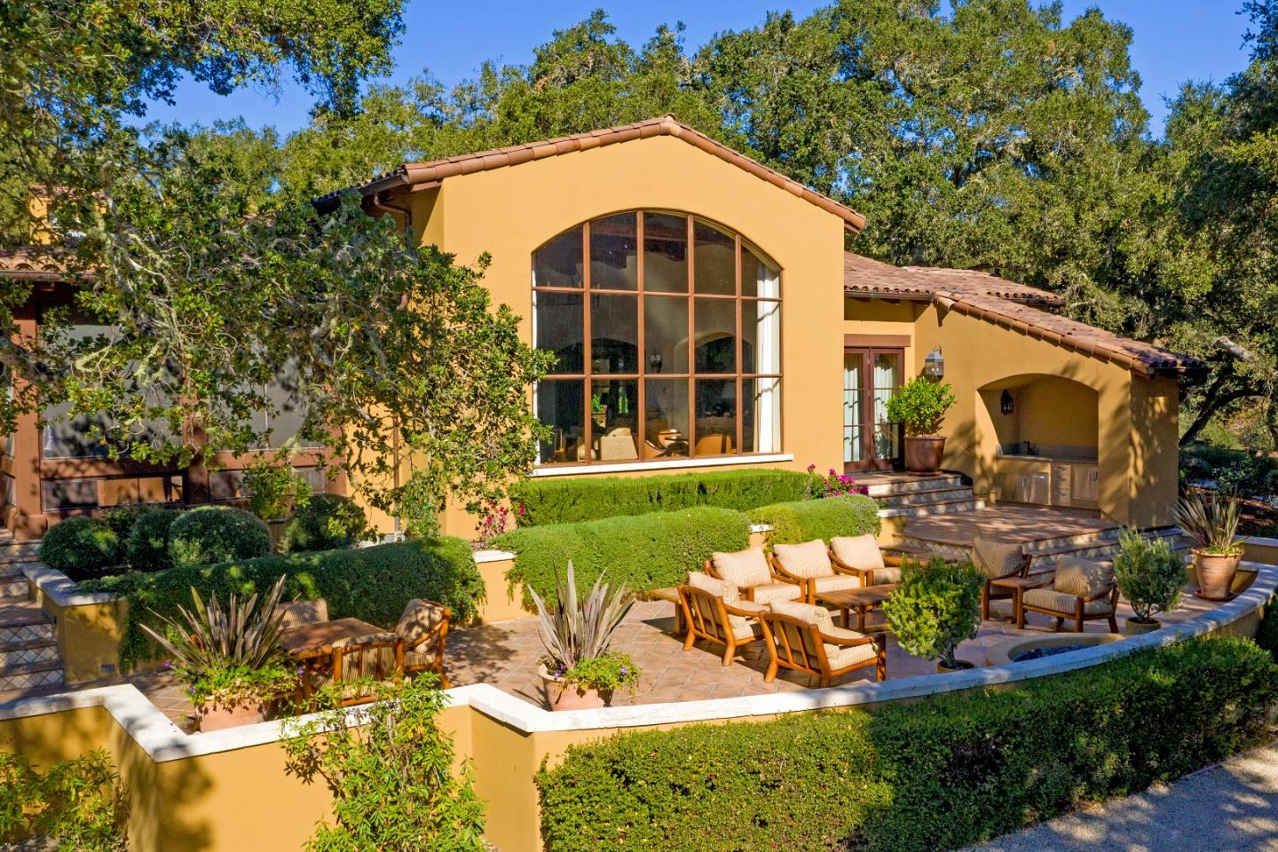 a view of a house with backyard sitting area and garden