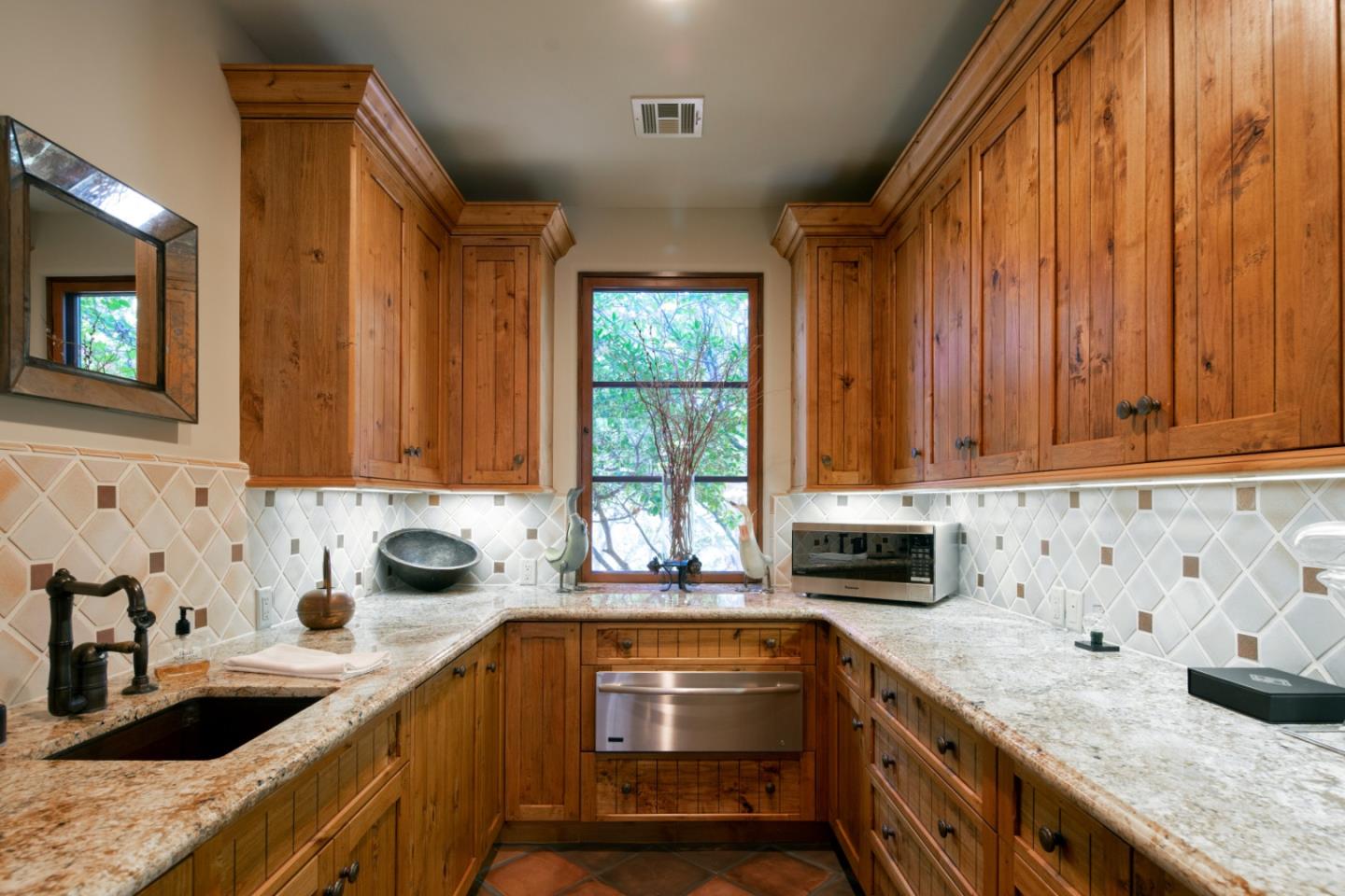 35 Rancho San Carlos Road Carmel, CA 93923 - Photo 18 of 47 a kitchen with granite countertop a sink a stove and cabinets