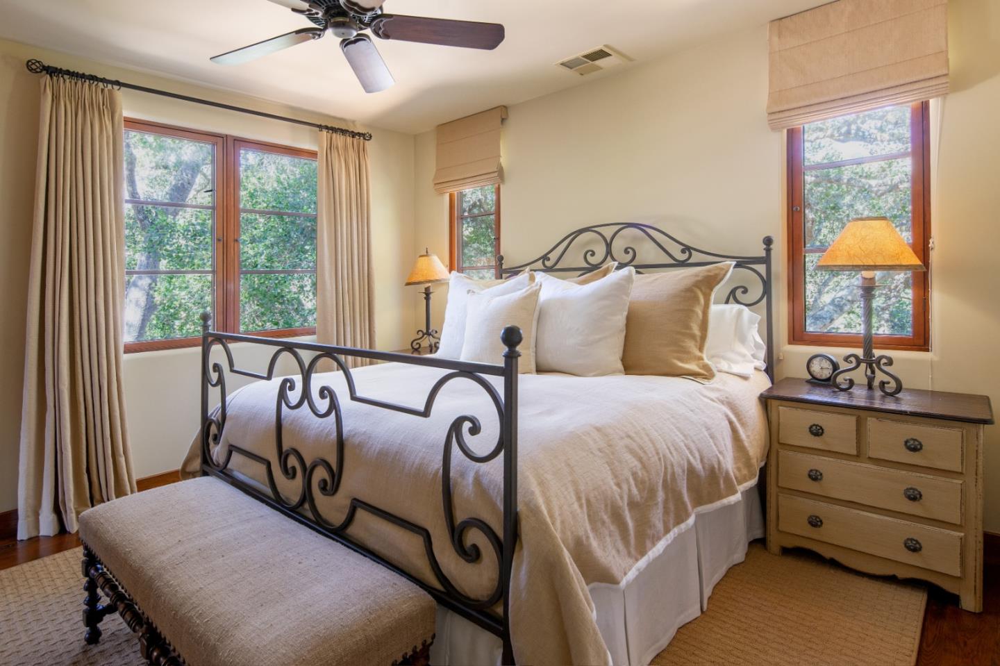 35 Rancho San Carlos Road Carmel, CA 93923 - Photo 43 of 47 a bedroom with a bed and a chandelier