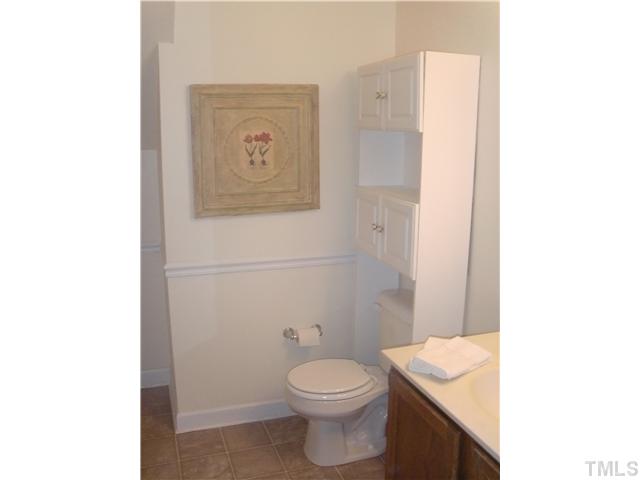 6800 Glendower Road Raleigh, NC 27613 - Photo 13 of 14 a bathroom with a toilet a sink and mirror