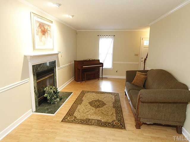 6800 Glendower Road Raleigh, NC 27613 - Photo 3 of 14 a living room with furniture and a fireplace