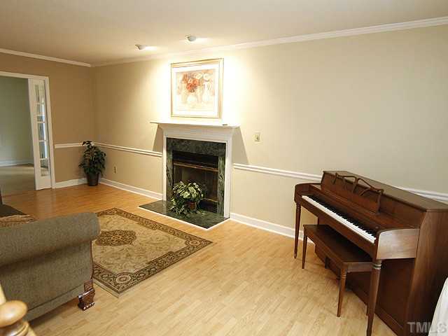 6800 Glendower Road Raleigh, NC 27613 - Photo 4 of 14 a room with furniture and a fireplace