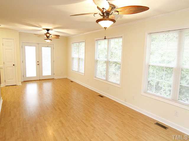 6800 Glendower Road Raleigh, NC 27613 - Photo 7 of 14 a view of an empty room with a window and wooden floor
