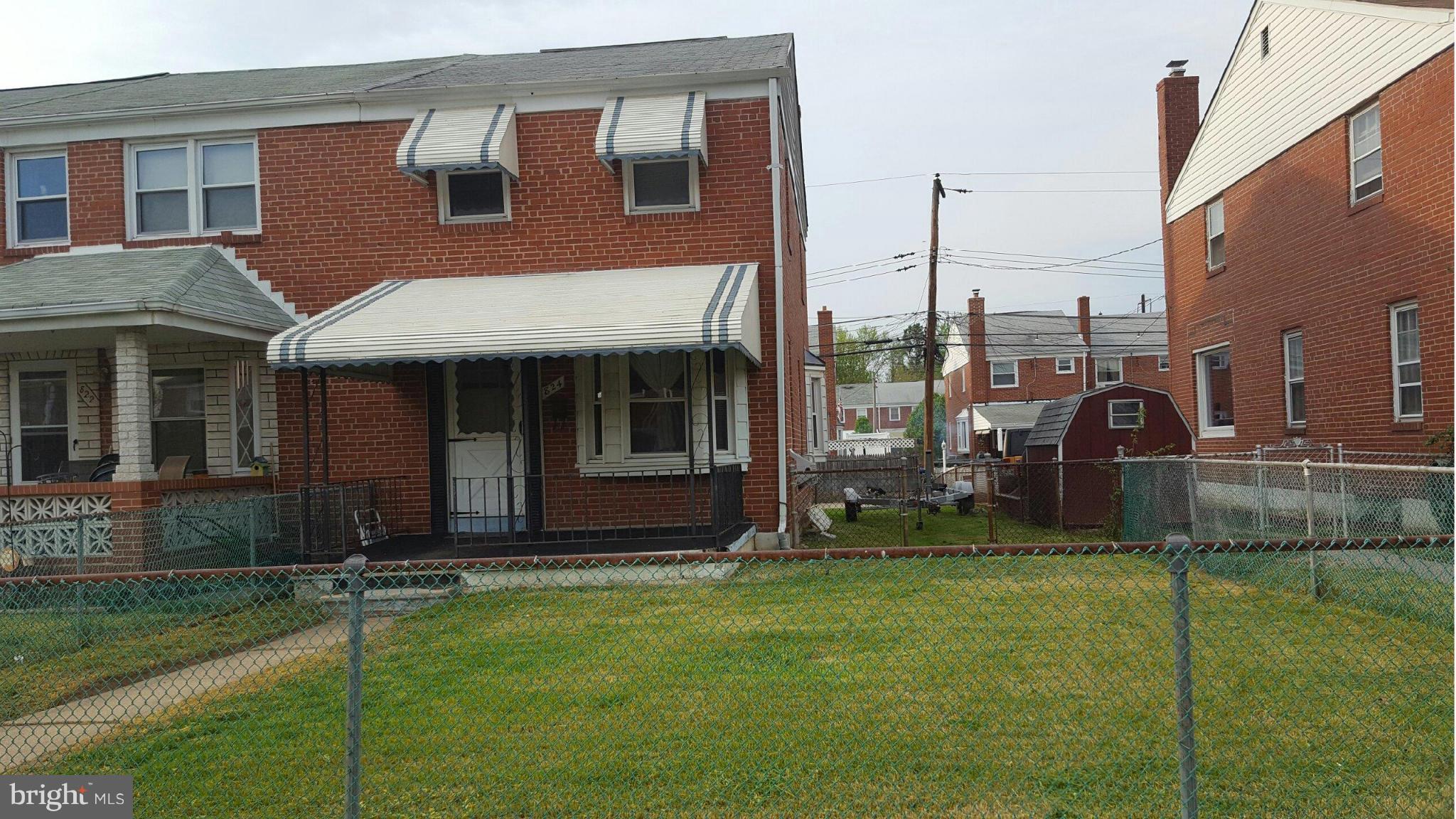 824 Arncliffe Road Baltimore, MD 21221 - Photo 1 of 7 a front view of a house with a yard
