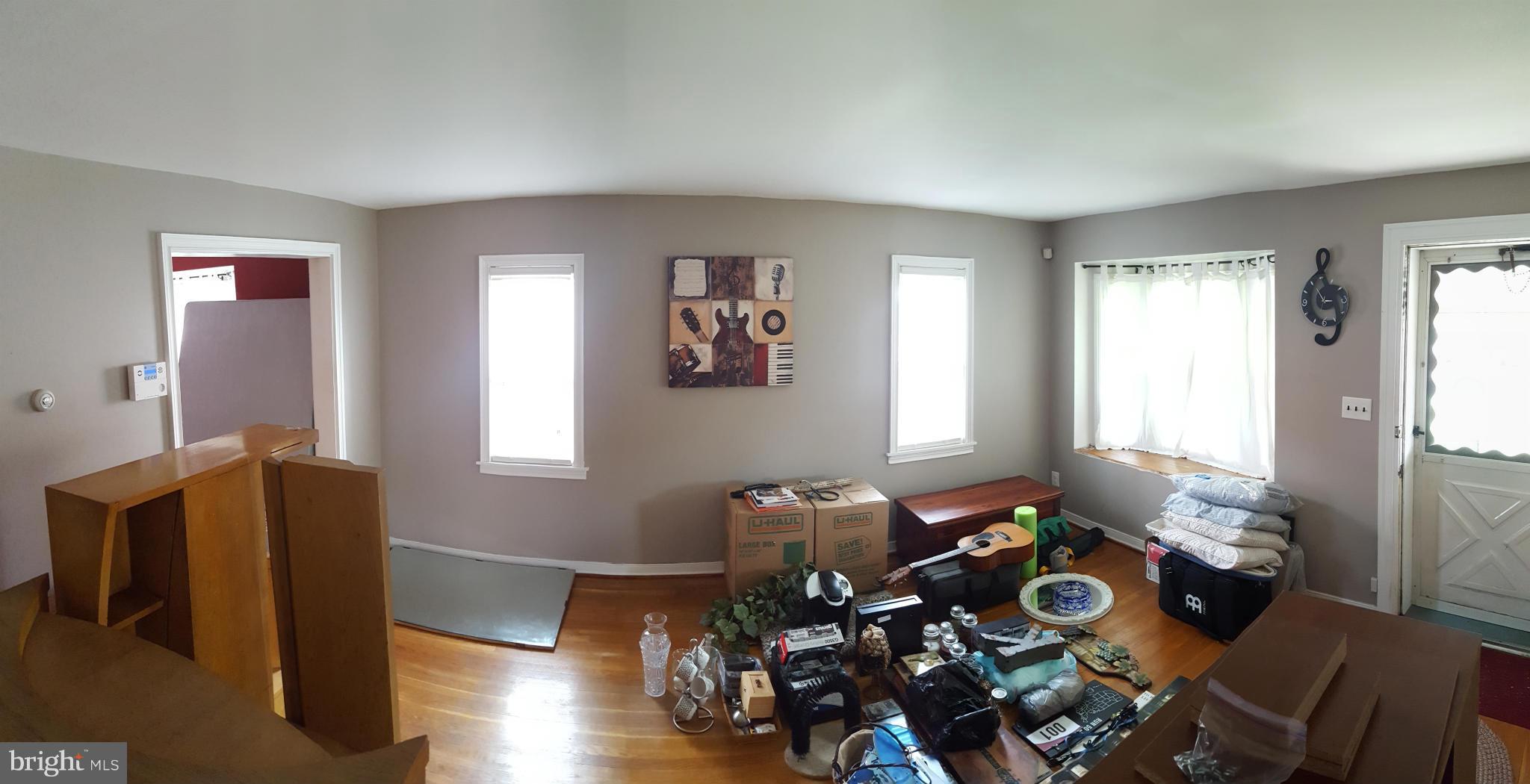824 Arncliffe Road Baltimore, MD 21221 - Photo 2 of 7 a living room with furniture and wooden floor