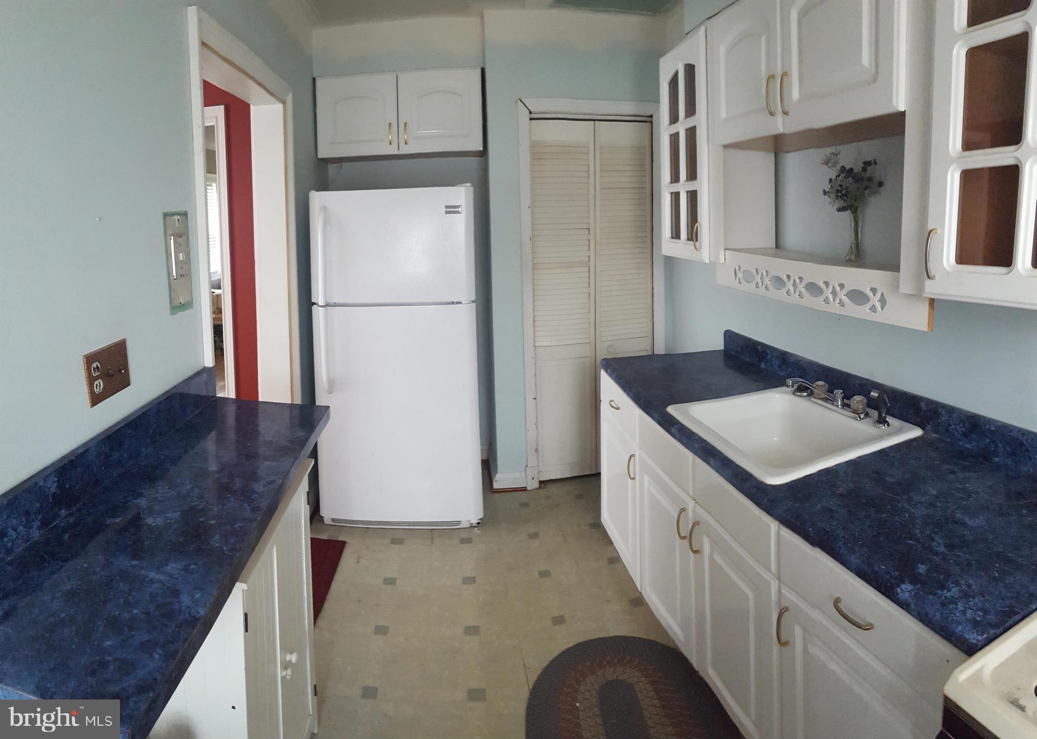 824 Arncliffe Road Baltimore, MD 21221 - Photo 4 of 7 a kitchen with a sink stove and refrigerator