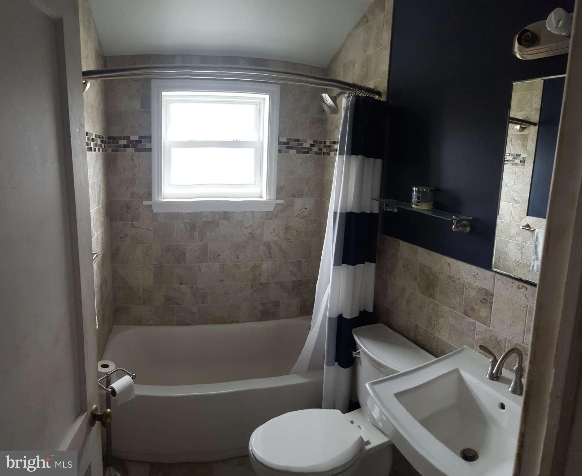 824 Arncliffe Road Baltimore, MD 21221 - Photo 5 of 7 a bathroom with a sink toilet and bathtub