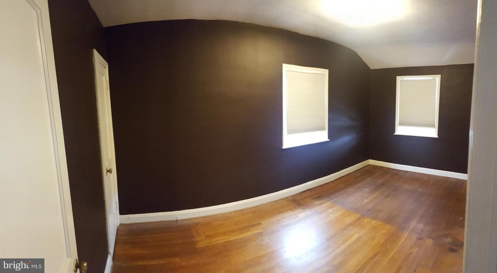 824 Arncliffe Road Baltimore, MD 21221 - Photo 6 of 7 a view of empty room with wooden floor