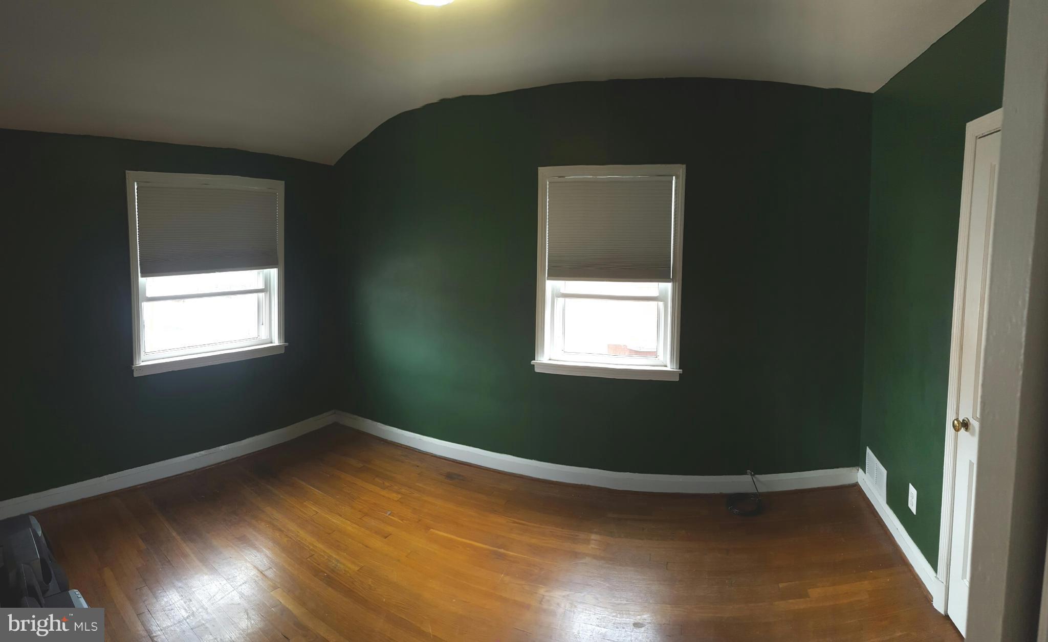 824 Arncliffe Road Baltimore, MD 21221 - Photo 7 of 7 a view of a small space with wooden floor and a window