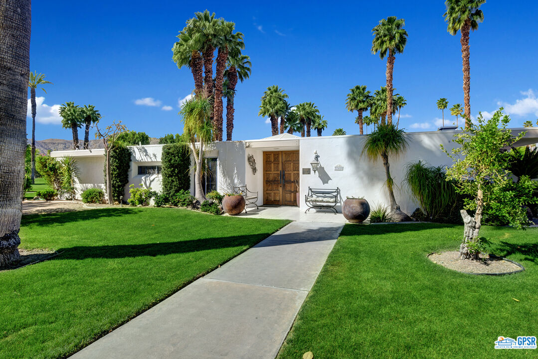 37659 Palm View Road Rancho Mirage, CA 92270 - Photo 1 of 48 a view of a house with a swimming pool and a yard