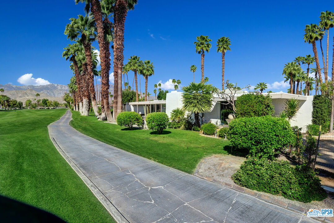 37659 Palm View Road Rancho Mirage, CA 92270 - Photo 3 of 48 a view of a garden with a building in the background