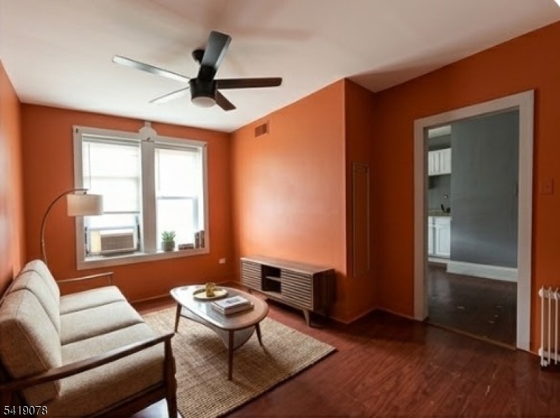 73 4th Street, Unit B1 Passaic, NJ 07055 - Photo 6 of 12 a living room with furniture and a window