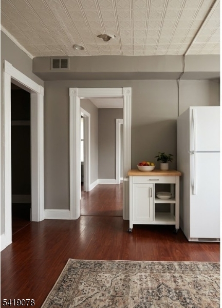 73 4th Street, Unit B1 Passaic, NJ 07055 - Photo 10 of 12 a view of kitchen and hallway with wooden floor