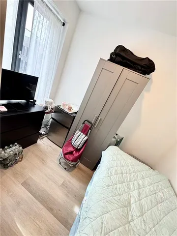 a bedroom with a bed and a chair