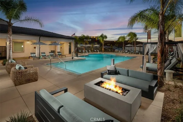a view of a patio with couches and a fire pit