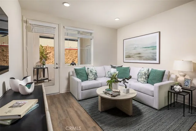 a living room with furniture and floor to ceiling windows
