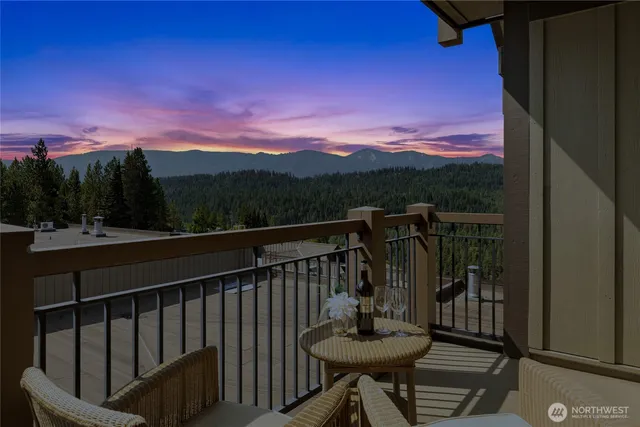 a view of a balcony with chair and wooden floor