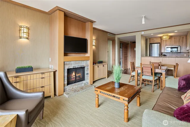 a living room with furniture a flat screen tv and a fireplace