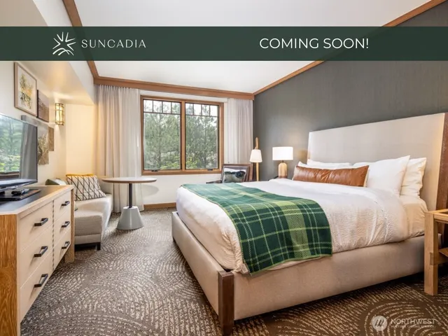 a bedroom with bed and a large window