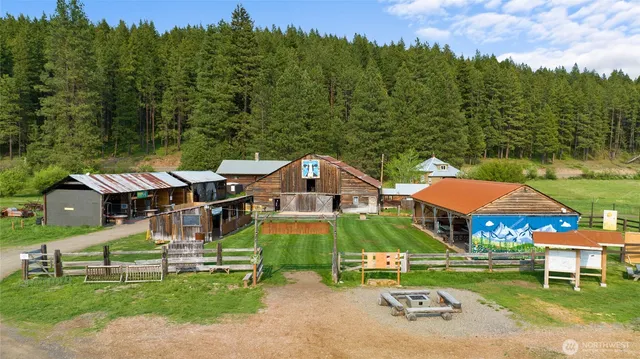 an aerial view of a house with garden space and trees