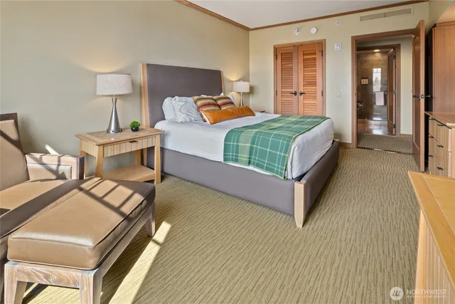 a bedroom with a bed and a lamp