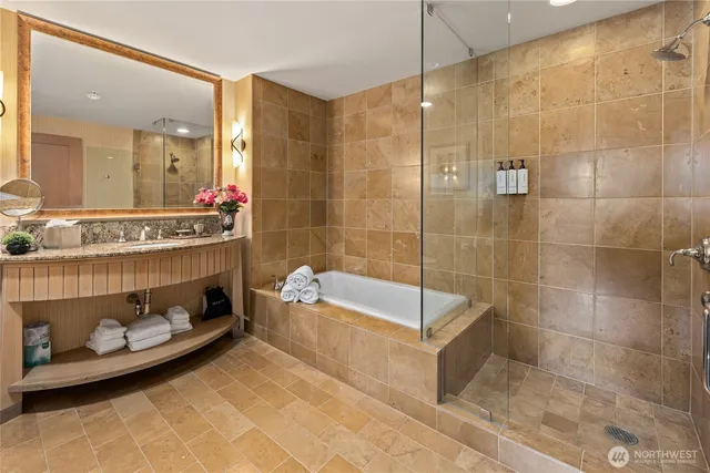 a bathroom with a tub a sink and shower