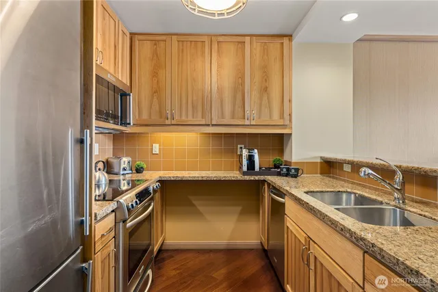 a kitchen with a sink stove and cabinets
