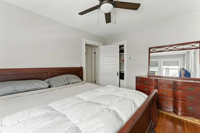 a bedroom with a large bed and a dresser