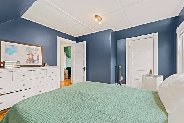 a bedroom with a large bed and a large window