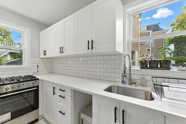 a kitchen with stainless steel appliances a sink stove and microwave