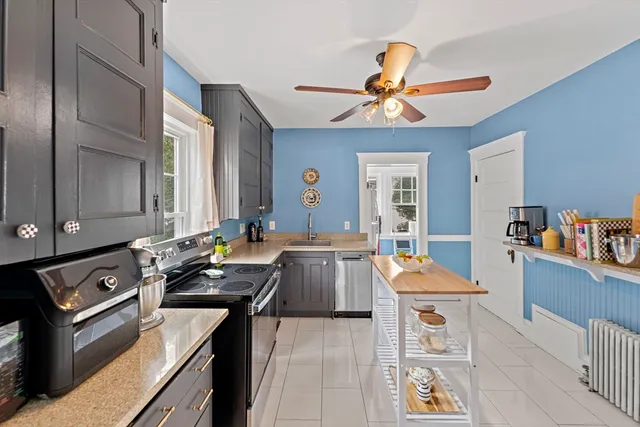a kitchen with a stove a sink and a refrigerator
