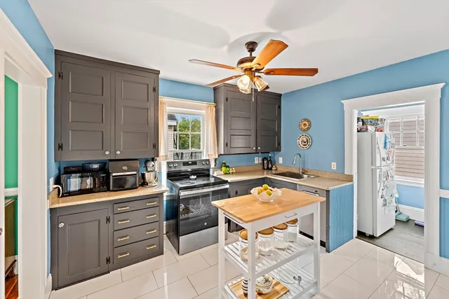 a large kitchen with stainless steel appliances granite countertop a stove and a sink