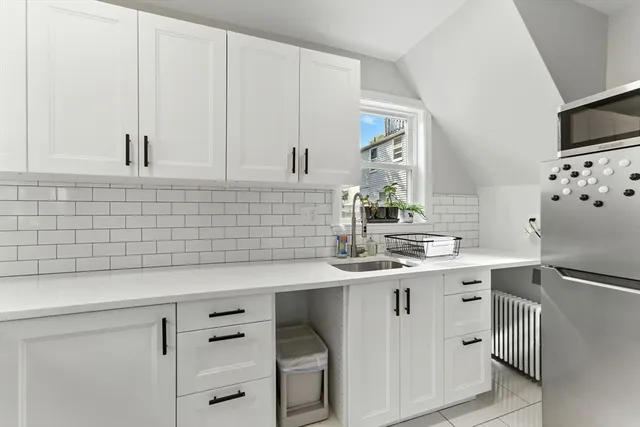 a kitchen with a sink and cabinets