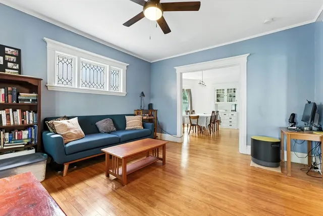 a living room with furniture and a wooden floor