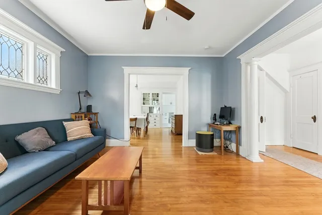 a living room with furniture and wooden floor